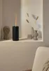 An aroma diffuser is placed on a shelf next to decorative items, with a hint of smoke or mist rising from it. Náhľad obrázku produktu