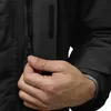 A close-up of a person's hand interacting with a zipper on a black jacket. Produktbild-Vorschau