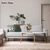 A living room scene with a sofa, coffee table, and plants. Náhled obrázku produktu