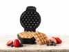A bubble waffle maker with two waffles and some berries on a countertop. Náhľad obrázku produktu