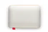A top-down view of a white memory foam pillow with a textured surface and a gold trim. A small red tag with a cloud logo is attached to the bottom left corner. Produktbild-Vorschau