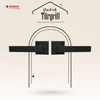 A marketing image showcasing two black door handles with square rosettes, set against a light beige background with a geometric pattern. The image features text and a brand logo. Produktbild-Vorschau