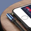 A close-up shot of a blue 90-degree angled audio AUX cable plugged into a smartphone. Produktbild-Vorschau