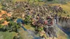 A sprawling city built on a cliff overlooking a river and surrounding landscape, with a waterfall cascading down the cliff face. Podgląd zdjęcia produktu