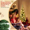 A family is gathered around a Christmas tree, reading a book. Voir les images du produit