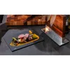 A gourmet meal is presented on a black slate plate, with a wooden cutting board and knife block in the background. Podgląd zdjęcia produktu
