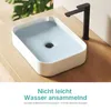 A modern bathroom sink with water and a faucet. Voir les images du produit
