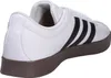 A side view of a white Adidas sneaker with black stripes and a brown sole. Anteprima dell’immagine prodotto