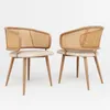 Two modern dining chairs with rattan backs and beige upholstered seats, arranged on a white background. Voir les images du produit