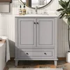A gray vanity cabinet with a white countertop and sink in a bathroom setting. Náhled obrázku produktu