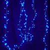 Strings of blue LED lights hanging against a dark blue fabric background. Produktbild-Vorschau