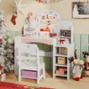 A child's vanity desk decorated for Christmas, with a Christmas tree and festive decorations in the background. Náhled obrázku produktu