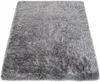 A close-up, angled view of a shaggy gray rug. Produktbild-Vorschau