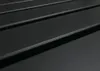 A close-up, angled view of a black, slatted surface. Náhľad obrázku produktu