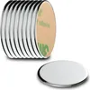A stack of round, silver magnets with adhesive backing is shown, with one magnet in the foreground. Náhľad obrázku produktu