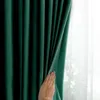 A hand is shown pulling back a dark green curtain, revealing a sheer white curtain behind it. Produktbild-Vorschau