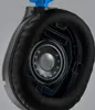 A close-up, cutaway view of a gaming headset's internal speaker and earcup. Produktbild-Vorschau