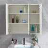A white bathroom medicine cabinet with mirrored doors, open to reveal shelves with various toiletries and decorative items. A sink and faucet are visible below. Produktbild-Vorschau