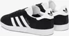 A pair of black Adidas Gazelle sneakers with white stripes and soles, shown from a side-angle. Produktbild-Vorschau