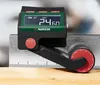 A digital measuring tool is shown attached to a metal ruler and resting on a wooden surface. Anteprima dell’immagine prodotto