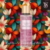 A bottle of Victoria's Secret Velvet Petals fragrance mist is centered against a vibrant, floral background. Podgląd zdjęcia produktu