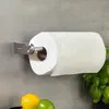 A paper towel holder mounted on a gray wall, with a roll of paper towels on it. Some lemons and limes are visible at the bottom. Náhľad obrázku produktu