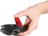 A hand is holding a black and red kitchen utensil. Produktbild-Vorschau