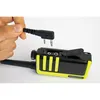 A hand is holding a connector plug above a black and yellow Kenwood walkie-talkie. Náhled obrázku produktu