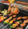 A close-up shot of food being grilled on a barbecue. Produktbild-Vorschau