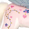 Close-up of a pink plush unicorn with embroidered decorations. Produktbild-Vorschau