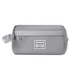 A gray toiletry bag with a handle and a small label. Produktbild-Vorschau
