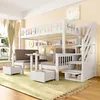 A children's bunk bed with a desk and seating area, set up in a bedroom. Voir les images du produit