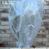 A plant wrapped in bubble wrap, placed in front of a brick wall. Produktbild-Vorschau