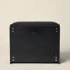 A black storage bench with a padded seat is shown against a plain, light-colored background. Náhľad obrázku produktu