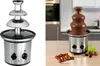 A split image showing a chocolate fountain. The left side shows the fountain empty and clean, while the right side shows it with melted chocolate and fruit skewers. Podgląd zdjęcia produktu