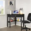 A black corner desk with a laptop, lamp, and books is set up in a room with a window. Produktbild-Vorschau
