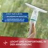 A hand holding a window cleaning device against a blurred green background. Produktbild-Vorschau