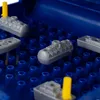 A close-up view of toy ships placed on a blue grid, likely a game board. Náhľad obrázku produktu