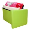 A green storage ottoman filled with decorative pillows. Produktbild-Vorschau