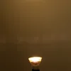 A single light bulb is shown against a plain, dark background. Produktbild-Vorschau