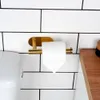 A close-up shot of a gold toilet paper holder mounted on a white tiled wall. Produktbild-Vorschau