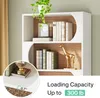 A modern white bookshelf with wooden accents, displaying books, a decorative giraffe statue, and a potted plant. A close-up inset shows a detail of the shelf edge and a woven basket. Produktbild-Vorschau