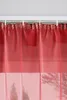 A close-up view of red sheer curtains hanging from a curtain rod. Produktbild-Vorschau