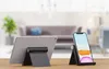 Two electronic device stands on a wooden table in a living room setting. Náhľad obrázku produktu
