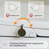 Close-up of a white toilet seat with control dial and instructional diagrams showing different spray functions. Produktbild-Vorschau