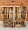 Two wooden crates with shelves are displayed against a wooden wall. Náhled obrázku produktu