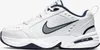 A side view of a white Nike Air Monarch IV sneaker with navy and gray accents. Náhled obrázku produktu