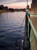 A person fishing from a bridge at dusk. Produktbild-Vorschau