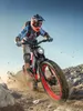 A person riding an electric mountain bike off-road. Produktbild-Vorschau