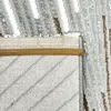 Promienny dywan z abstrakcyjnym wzorem i połyskującymi Podgląd zdjęcia produktu 9